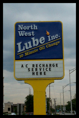 North West Lube illuminated pole sign shown during the day