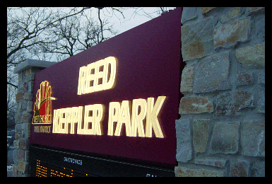 Park sign with push through plastic and LED message board shown at dusk.